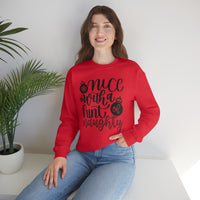 Nice with a Hint of Naughty Unisex Heavy Blend Crewneck Sweatshirt! Winter Vibes!